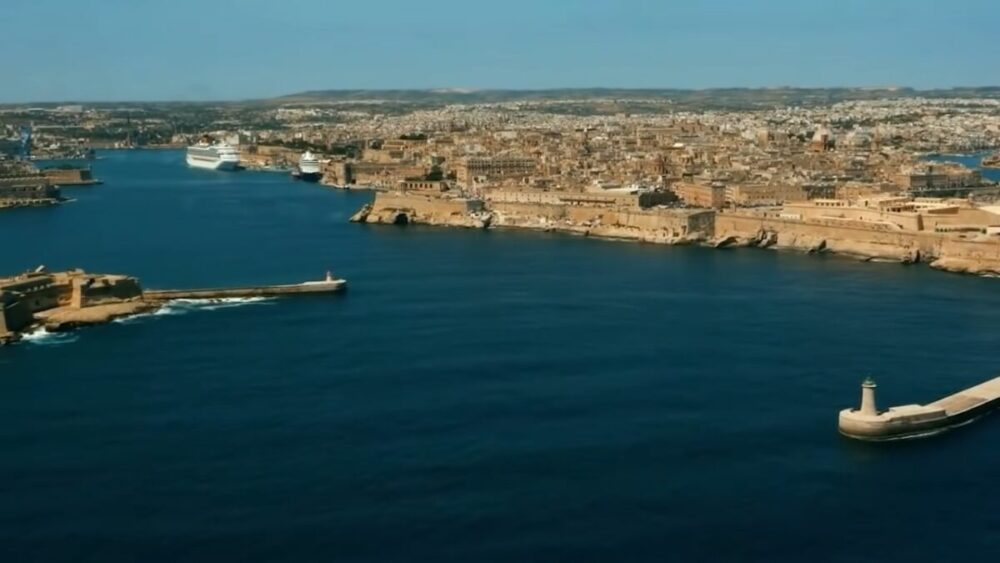 Aerial view of Valletta’s waterfront and Grand Harbour under a clear blue sky