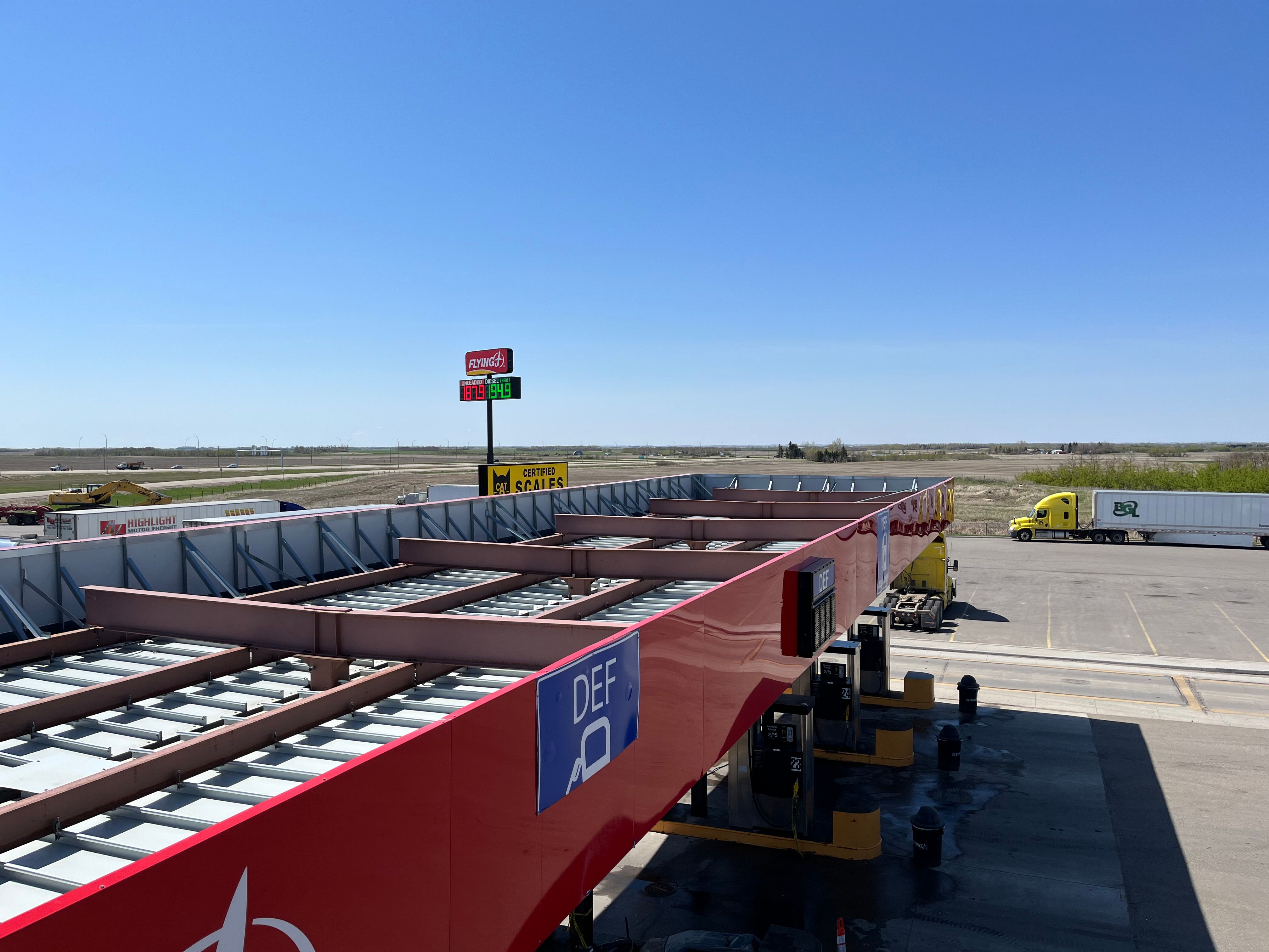 Aerial view of a highway truck stop with gas station and parking lot for long-haul drivers