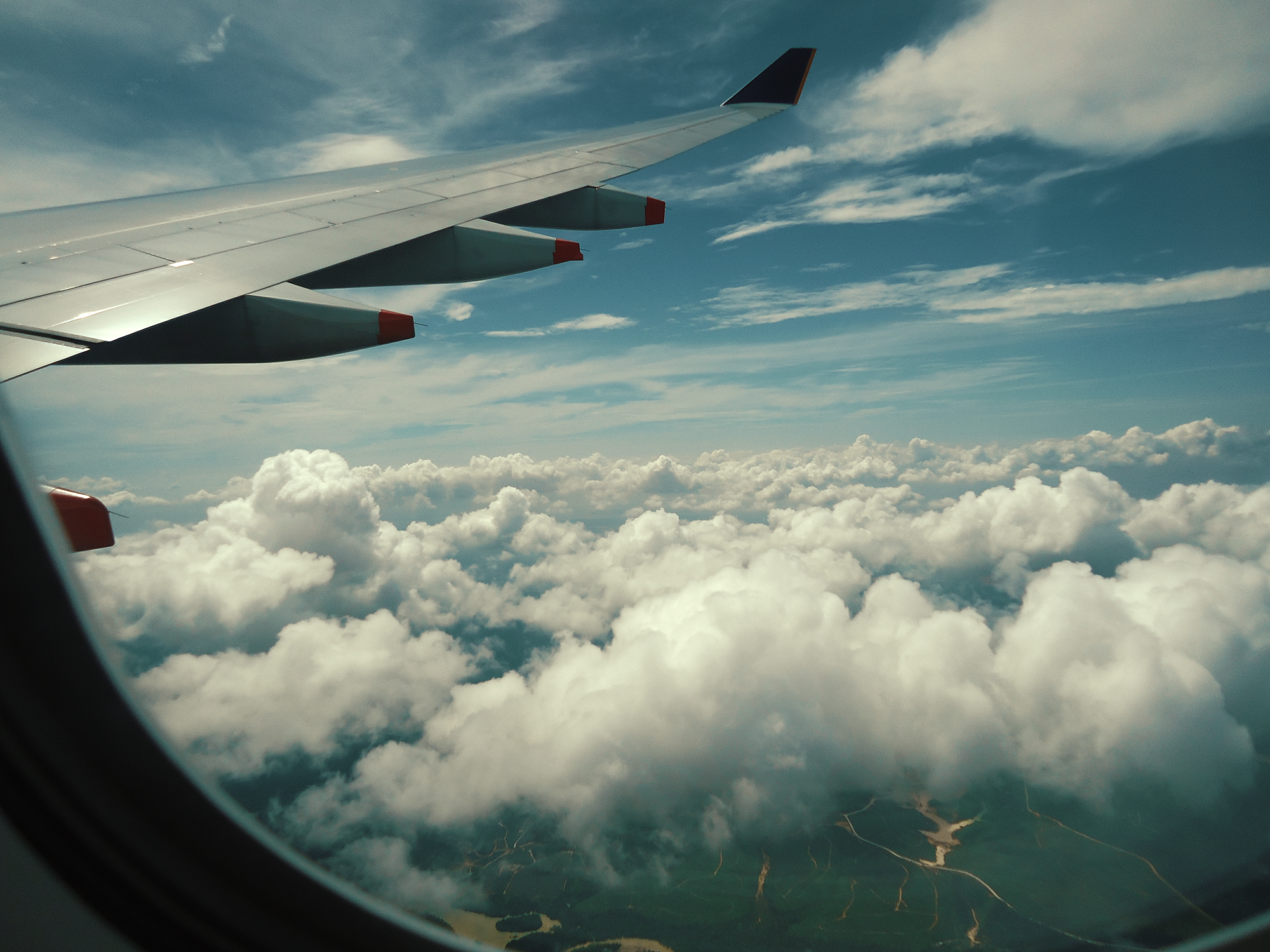 Fluffy white clouds seen from an airplane window during a business flight
