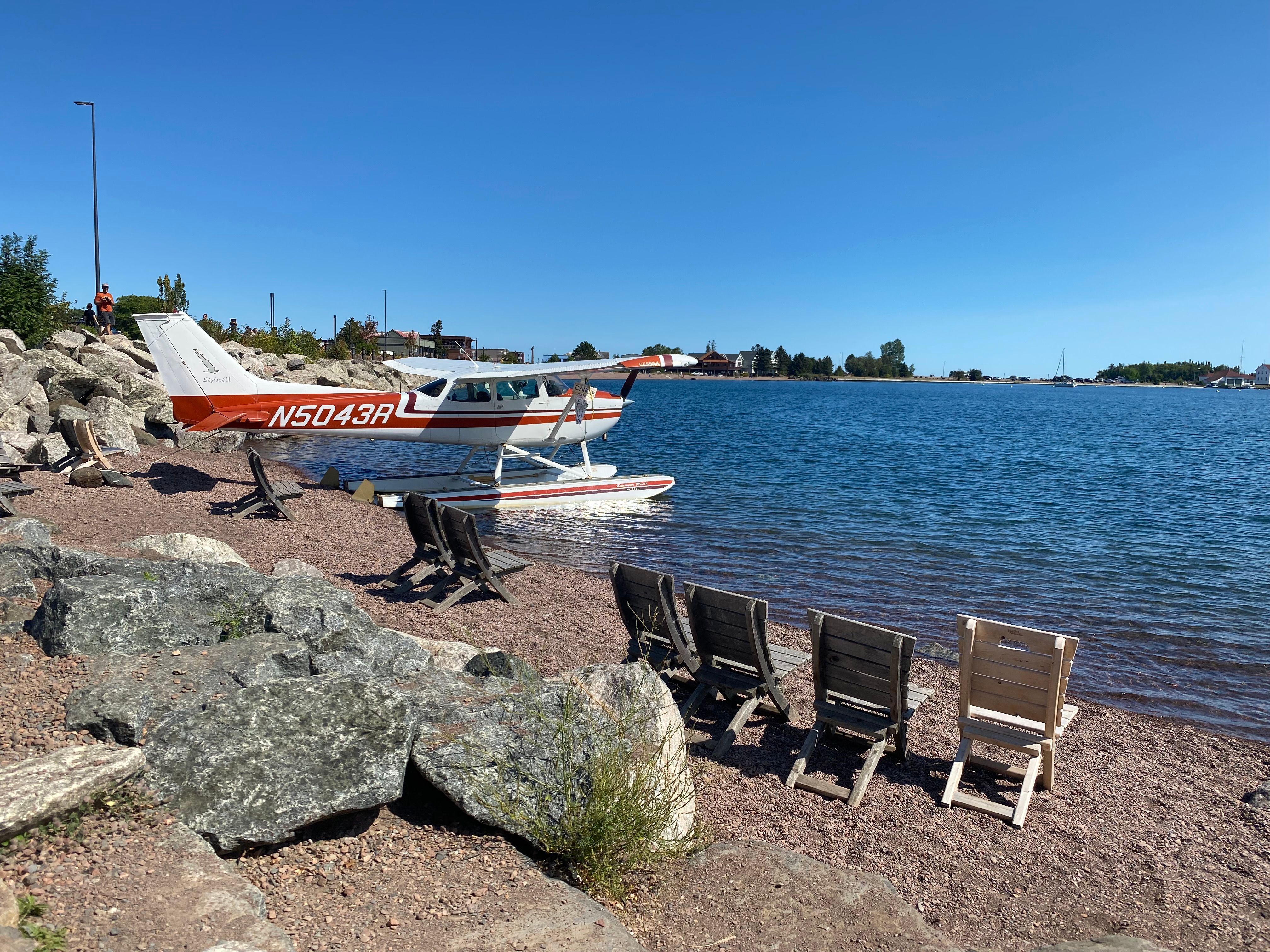Seaplane docked beside Lake Superior in Grand Marais, Minnesota, reflecting the region's varied aviation options.